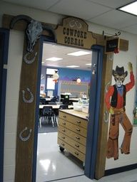 an open door to a classroom with a cowboy mural on the front and back wall