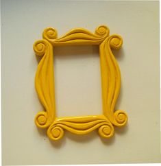 a yellow frame sitting on top of a white table