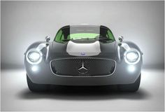 the front end of a silver and black sports car with lights on it's headlight