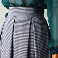 "With your choice you support a small Italian artisan business. A thousand thanks. Women's skirt. This item is handmade in micro houndstooth fabric. Wonderful Italian fabric. Soft but consistent hand. Suitable for the autumn winter season. The skirt is made with kissed pleats, both front and back and on the sides. Equipped with a 4 cm high bustier, calculated at the natural waist. The skirt has an opening on the back with a matching zip. Finished internally, with lining. It is an elegant garment Elegant Black Skirt With Houndstooth Pattern, Elegant Black Houndstooth Pattern Skirt, Elegant Black Houndstooth Skirt, Elegant Houndstooth Skirt For Office, Houndstooth Skirt For Work, Houndstooth Skirt For Workwear, Houndstooth Workwear Skirt, Chic Gingham Skirt For Work, Fitted Gingham Skirt With Lining