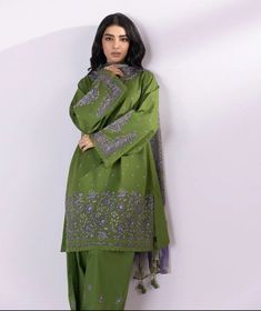 Indulge in traditional elegance with our juniper green and violet three-piece embroidered suit featuring a lawn shirt, viscose chiffon dupatta and cambric pants. Unstitched 3-Piece Shirt: Dyed Embroidered Lawn Shirt Front 1.15M Dyed Embroidered Lawn Shirt Sleeves 0.66M Dyed Lawn Shirt Back 1.15M Embroidered Sleeves Motifs 2PC Embroidered Neckline 1PC Fabric: Lawn Colour: Juniper Green Dupatta: Printed Viscose Chiffon Dupatta 2.5M Fabric: Viscose Chiffon Colour: Juniper Green And Violet Trousers: Green Kurta With Naqshi And Traditional Drape, Green Kurta With Naqshi In Traditional Drape, Green Anarkali Lawn Suit With Traditional Drape, Green Designer Anarkali Lawn Suit, Green Anarkali With Naqshi Detailing, Festive Green Naqshi Dupatta, Elegant Green Salwar Kameez With Naqshi Details, Traditional Green Dupatta With Naqshi, Designer Green Salwar Kameez With Chikankari Embroidery