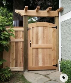 a wooden gate with an arched top