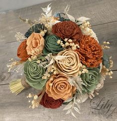 a bridal bouquet with orange, green and brown flowers