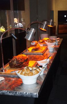 a buffet table filled with different types of food and drinks on it's sides