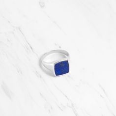 Experience the perfect blend of timeless sophistication and contemporary allure with our Ray Lapis Lazuli Large Square Signet Ring. This striking ring is meticulously crafted to make a bold statement, featuring a captivating lapis lazuli gemstone at its centre, radiating with deep, celestial blue hues. Details Stone: Lapis Lazuli Material: Sterling Silver 925 and Gold Vermeil If you would like to wear this ring as a wedding band, we can make it in solid gold. For inquiries or quotations, please Modern Jewelry With Vs Clarity Round Band, Modern Jewelry With Timeless Round Design, Elegant Gemstone Signet Ring For Formal Occasions, Timeless Design Jewelry Gift, Modern Jewelry With Polished Round Band, Elegant White Gold Sterling Silver Signet Ring, Silver Jewelry With Timeless Design For Gift, Modern Rings With Timeless Round Cut Design, Refined White Gold Ring With Timeless Design