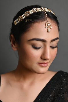 a woman wearing a head piece with pearls