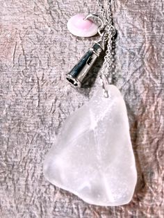 Dainty Sea Glass Necklace, Handmade with love! Genuine, authentic beach glass pendant with natural sparkle, sanitized & polished. Hypoallergenic, tarnish-free 18" silver plated stainless steel chain & lobster claw clasp. Adorable Silver plated stainless steel nautical themed Lighthouse Charm in a silver plated stainless steel, and pink puka shell adds a touch of elegance and fun. Perfect for beach weddings, date nights, or everyday minimalist style. Upcycled sea glass jewellery, ideal for women who adore natural beauty. Clear Glass Jewelry For Beach, White Glass Necklaces For Beach, White Glass Necklaces For The Beach, White Glass Beach Necklace, White Glass Beach Jewelry, Glass Beach, Sea Glass Beach, Glass Jewellery, Puka Shell