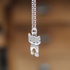 This tiny little dancing cat charm measures 3/4 of an inch tall. It can be ordered as a charm "charm only" or as a necklace on an adjustable sterling silver chain.The chain can be latched on any link between 16 and 20 inches. Cute Sterling Silver Pendant Charm Necklaces, Cute Sterling Silver Pendant Charm Necklace, Cute Silver Charm Necklaces With Lobster Clasp, Cute Hypoallergenic Silver Charm Necklaces, Cute Silver Charm Necklaces, Silver Cat Design Pendant Charm Necklace, Cute Nickel-free Silver Charm Necklace, Cute Silver Nickel-free Charm Necklaces, Cute Silver Charm Necklaces For Everyday