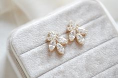 This pair of stunning rose gold cubic zirconia stud bridal earrings was meant to be worn by ladies on the most special day of their lives. Ever since we created the design for this elegant piece of jewelry, we imagined a romantic, modern bride wearing them as she walks down the aisle – and seeing them, we bet you can imagine yourself wearing them too!- Handcrafted with Premium cubic zirconia stones - All clear stones - Rhodium, yellow gold or rose gold finish- Earrings measures 1.25" x .625"- Ni Rose Gold Cubic Zirconia Diamond Earrings For Wedding, Dazzling Rose Gold Wedding Earrings, Dazzling Rose Gold Earrings For Wedding, Rose Gold Diamond Crystal Earrings For Wedding, Rose Gold Diamond Bridal Earrings For Wedding, Dazzling Rose Gold Bridal Earrings For Anniversary, Elegant Rose Gold Crystal Earrings With Cubic Zirconia, Rose Gold Diamond Crystal Earrings With Sparkling Stones, Rose Gold Bridal Earrings With Sparkling Cubic Zirconia