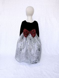 A gorgeous dress that can be worn for a Christmas party, birthday, photoshoot, or pageant! Long sleeve bodice is made out of soft velvet. The zipper can be found on the back of the dress. Comes with a detachable embroidery bow. The skirt is made out of a detailed embroidery fabric with lining underneath. One last layer of lining with crinoline attached underneath everything to give the dress shape. *Mannequin has petticoat to show detail. !PETTICOAT NOT INCLUDED! LINK TO PURCHASE PETTICOAT: http Christmas Princess Ball Gown Dresses, Holiday Princess Dress With Bow, Holiday Princess Dress For Fancy Dress, Christmas Princess Dress With Bow, Princess Style Christmas Dress For Fancy Dress Occasion, Princess Style Pink Dress For Christmas Fancy Dress, Princess Style Christmas Fancy Dress, Holiday Princess Dress Ball Gown For Dress-up, Christmas Wedding Princess Dress With Bow