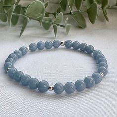 A beautiful handmade Angelite beaded bracelet. This stretch bracelet is perfect for crystal healing, an energy beaded bracelet featuring genuine, ethically sourced 6mm Angelite gemstone beads and your choice of 925 Sterling Silver or 14k Gold Filled accent beads. This minimalist gemstone bracelet is designed and handmade in the UK and can be worn solo for a subtle look or stacked with others to create a unique, custom bracelet stack. This pale blue gemstone bracelet is unisex so is the perfect g Minimalist Hand-strung Beaded Bracelets For Meditation, Minimalist Gemstone Beaded Bracelets For Meditation, Minimalist Round Beads Crystal Bracelet For Healing, Minimalist Crystal Bracelet With Round Beads For Healing, Everyday Blue Gemstone Beads Stretch Bracelet, Everyday Blue Stretch Bracelet With Gemstone Beads, Minimalist Gemstone Beaded Bracelets For Healing, Minimalist Bracelets With 8mm Beads For Healing, Minimalist Beaded Bracelets For Healing