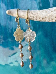 Beautiful carved mother of pearl flower on gold vermeil earrings with a labradorite tear drop gemstone and champagne fresh water pearls.  High quality gold vermeil earrings.  The earrings measure approximately 2 3/4" long.  Flower is approximately 1".  Freshwater pearl dangle measures 1.5". Simple and elegant chic look! Beautiful bridesmaid gift, perfect for a beach wedding! Ships ready for gifting in wrapped in a gauze bag. Unique Pearl Drop Jewelry, Fine Jewelry Dangle Pearl Charm, Delicate Drop Flower Earrings With Pearl Charm, Unique Pearl Jewelry For Anniversary, Elegant Pierced Jewelry In Mother Of Pearl, Elegant Mother Of Pearl Jewelry, Dangle Jewelry With Pearl Charm For Anniversary, Dainty Pearl Drop Flower Earrings, Anniversary Pearl Charm Dangle Jewelry