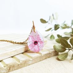 This Cherry blossom necklace is part of my cherry blossom jewelry collection. The sakura flower is highly admired in Japan, so take this sakura flower necklace with you to wear a little piece of this magic beauty. This real flower necklace will never make you go unnoticed because it is really elegant and unique. A cherry blossom necklace to have the Spring always with you... The chain is made of hypoallergenic stainless steel. The resin provides this cherry blossom necklace a perfect crystalline Feminine Flower Pendant Necklace As A Gift, Delicate Flower Necklace For Her, Feminine Flower-shaped Necklaces For Gifts, Dainty Blossom Flower Jewelry, Dainty Pink Pendant Flower Necklace, Gift Flower Pendant Necklace With Flower Decoration, Blossom Colored Flower Pendant Jewelry Gift, Blossom Petal Shaped Jewelry For Gifts, Blossom Color Flower Pendant Jewelry As Gift