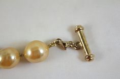 "Carolee faux champagne color glass baroque pearl necklace Measures 17 inches long gold vermeil over sterling toggle style clasp the pearls are 1/2\" wide and long Excellent condition on beads" Formal Pearl Bracelet With Round Beads And Pendant, Gold Pearl Bracelet With Pearl Pendant, Gold Pearl Bracelet With Round Beads And Pendant, Formal Baroque Pearl Necklace With Round Beads, Vintage Gold Pearl Bracelet For Formal Occasions, Formal Yellow Gold Toggle Necklace, Formal Gold Pearl Necklace, Vintage Gold Pearl Drop Necklace, Vintage Gold Pearl Bracelet With Round Beads