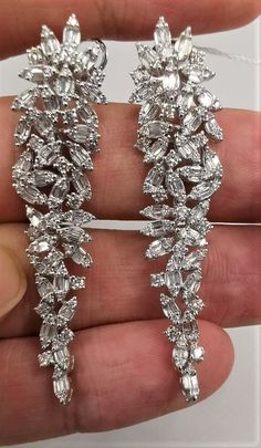 LAST CALL, LAST CHANCE LIQUIDATION SALE The Following Items we are offering is a Rare Important Spectacular and Brilliant 18KT Gold Large Gorgeous Fancy Cascading Diamond Drop Draping Earrings. Earrings consists of Rare Fine Magnificent Fancy Glittering Diamonds. T.C.W. with approx 3.75CTS of Fancy Baguette and Trillion Cut Diamonds These Magnificent Earrings are a Rare Sample Pair and from a Private Manufacturer that sold to Important 5 Star Hotel and Fine Jewelry Stores and come NWT $18,559 and with a Gemological Certificate! A Pair of Exquisite Masterpieces!! We are in the Process of Liquidation and selling at BELOW DEALERS COST in order to stay in business WE PACK, SHIP, AND INSURE WORLDWIDE COME VISIT US AT:   ROYALE GALLERIES INC. 318 EAST 59TH STREET NEW YORK, NY 10022 212-308-0200 Mint Green Earrings, Rare Jewelry, 5 Star Hotel, Liquidation Sale, Greek Jewelry, Link Earrings, Expensive Jewelry, Star Hotel, Large Hoop Earrings