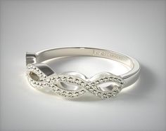 a white gold wedding band with an intricate design