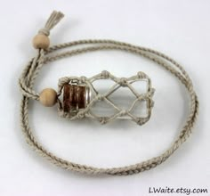 a white and brown cord with some beads on it