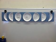 four plates are hanging on the wall with magnets