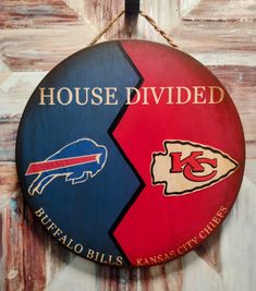 a wooden sign that says house divided with two images of buffalo bills and kansas city chiefs