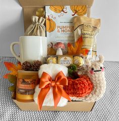 a basket filled with coffee, cookies and other things to eat for thanksgiving or fall