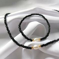 Black Round Beads Jewelry For Beach, Elegant Black Necklace For The Beach, Elegant Black Necklace For Beach, Black Beaded Necklaces With Pearl Charm Gift, Gift Black Beaded Necklaces With Pearl Charm, Black Beaded Necklace With Pearl Charm As Gift, Elegant Black Beads Beach Jewelry, Elegant Beach Jewelry With Black Beads, Elegant Black Beads Jewelry For Beach