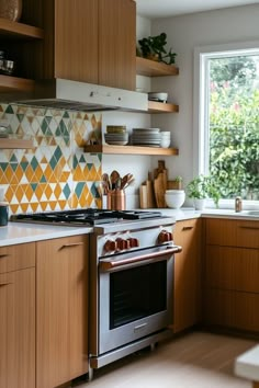 a kitchen with wooden cabinets and stainless steel stove top oven in front of a window