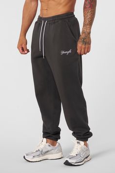 MATERIAL: 100% Cotton. 360 GSM FIT: Loose. DESIGN: The For Him joggers offer the ideal blend of comfort and style for the cooler fall and winter months. Featuring a loose fit that allows for easy movement, these joggers keep you cozy whether you're lounging or on the go. The simple embroidered logo adds a touch of branding while maintaining a clean and minimalistic look. MODEL: The model in the first photo is wearing a size Medium. Weight: 175lb Height: 5'9 Sporty Cotton Sweatpants For Streetwear, Sporty Baggy Joggers With Ribbed Cuffs, Athleisure Joggers With Letter Print For Loungewear, Cotton Sweats With Elastic Waistband For Streetwear, Athleisure Letter Print Joggers For Loungewear, Letter Print Joggers For Loungewear, Sporty Relaxed Fit Sweatpants For Streetwear, Baggy Cotton Sweatpants For Jogging, Athleisure Joggers With Letter Print And Relaxed Fit