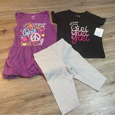 Purple Tank Top Dress Like Shirt Is Brand Extremely Me!, Size 5/6, Is Cinched At Sleeves With Fabric Band And At Bottom Hem With Elastic. Top Is In Euc. Black Shirt Is Jumping Beans Active, Size 5t, And Nwt. Silver Sparkle Shorts Are Bermuda (Knee) Length, Cartwheel Style, And Are 365 Kids Brand And A Size 5. Cute Short Sleeve Purple Set, Playful Stretch Black Tops, Playful Black Stretch Top, Black Playful Stretch Top, Stretch Playful Tops For Playtime, Playful Stretch Tops For Playtime, Playful Fitted Purple Tops, Casual Stretch Sets For Playwear, Purple Tops For Playtime In Summer