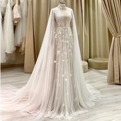 a wedding dress on display at a bridal shop, with the bride's veil draped over her shoulders