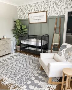 a baby crib in the corner of a room next to a dresser and chair