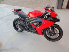 a red and black motorcycle parked on the street