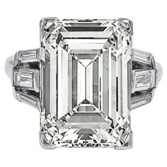 A stunning engagement ring boasting an emerald-cut diamond weighing 11.96 carats. Accompanied by a GIA report stating that the diamond is of O-P color, VS1 clarity. 6 tapered baguette diamonds on the sides. Metal is 18k white gold. Gross weight is 7.06 grams. Size 6.5. Sizable. Ruby Diamond Engagement Ring, Classic Diamond Engagement Ring, 100 Bill, Glam Wedding Dress, Emerald Cut Diamond Engagement Ring, Emerald Cut Diamond Engagement, Contemporary Engagement Rings, Wedding Outfit Ideas, Emerald Cut Diamond Ring