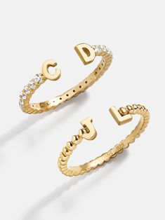 Our 18K Gold Double Initial Custom Ring is an updated take on a classic initial accessory. Available in an all-gold and a subtle sparkly version, these rings are ones you'll have for years to come. Add your own initials or that of you and a loved one to create a keepsake you'll cherish. Not to mention, this ring is crafted with 18K gold plated sterling silver and Cubic Zirconia stones. Gold Diamond Ring With Initials, Fine Jewelry, Gold Monogram Initial Ring Fine Jewelry, Gold Monogram Initial Ring In Fine Jewelry Style, Gold Sterling Silver Initial Stackable Ring, Gold Initial Ring With Round Cut Diamond Accents, Gold Sterling Silver Stackable Initial Ring, Luxury Yellow Gold Initial Ring For Everyday, Elegant Yellow Gold Stackable Initial Ring, Luxury Initial Ring With Vs Clarity