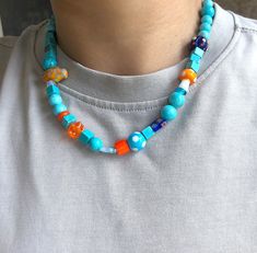 a man wearing a necklace with colorful beads on the front and back of his neck