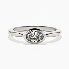 This Bezel Pinky Ring features an Oval Cut 0.50ct Lab-Grown Diamond in a bezel setting crafted in 14K White Gold, ring size 4. This ring can be resized to ring sizes 3, 3.25, 3.5, 3.75, 4.25, 4.5, 4.75, and 5. All Ready to ship Items are available for return/exchange as long as they are not resized or altered in any way. | Carat Weight: 0.50ct Band Width: 1.8mm. Classic Oval Diamond Ring With Bezel Setting, Oval Sterling Silver Ring With Single Diamond, Silver Oval Bezel Setting Wedding Rings, Oval Diamond Ring With Bezel Setting, Oval Smooth Bezel Promise Ring, Oval Bezel Set Ring For Wedding And Anniversary, Classic Oval Ring With Bezel Setting, Timeless Oval Ring With Bezel Setting, Classic Oval Rings With Bezel Setting