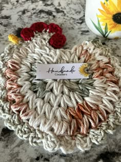 a crocheted pot holder with flowers on it