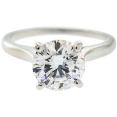 a white gold ring with a round brilliant cut diamond