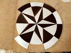 an image of a wooden table top that has been made into a dart board pattern