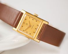 "Square wristwatch \"ZARIA\", a pre-owned vintage timepiece, a model with 17 jewels. Watch is in fully working order and professionally serviced. Mechanical movement, manual winding. The brand new genuine leather band is included. Year: 80s The case measures 0.78\" (2 cm) by 0.78\" (2 cm). Thanks for checking out my listing, let me know if you have any other questions. Express shipping worldwide is available. Just look at my shop shipping profile upgrades.  Please have a look at other vintage la Vintage Rectangular Watch For Everyday, Vintage Rectangular Everyday Watch, Vintage Everyday Rectangular Watch, Everyday Vintage Rectangular Watch, Vintage Rectangular Watch With Leather Strap, Wristwatch Vintage, Vintage Watches Women, Vintage Timepiece, Retro Watches