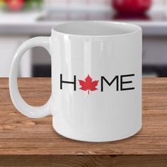 a white coffee mug with the word home printed on it