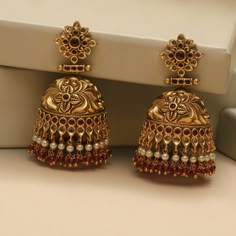 Description These antique jhumki earrings by Tarinika is a timeless design and sure will be your next favorite earrings. Crafted beautifully in nakshi pattern to give a luxurious look to your style. The antique gold color and colorful CZ stones and beads adds unique contrast to the design. Style them alone or match with other Tarinika antique jewelry. Details & Specifications: Materials used: Brass Alloy with Antique Plating Weight – 64 gm Length – 6.5 cm Make it custom Want to make it a custom Cheap Bollywood Style Jhumkas For Party, Indian Earrings Jhumka Tarinika Jewelry, Light Weight Jewelry Gold Indian, Luxury Gold Plated Jhumkas With Tilla, Luxury Gold Jhumkas For Ceremonial Occasions, Luxury Gold Plated Jhumkas With Intricate Design, Luxury Gold Round Jhumkas, Luxury Yellow Gold Jhumkas For Wedding, Luxury Kundan Jhumkas With Intricate Design