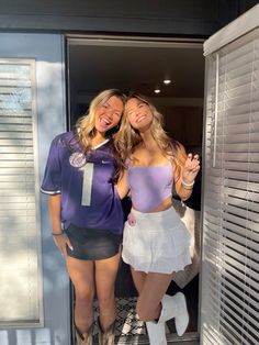 two beautiful young women standing next to each other in front of an open closet door