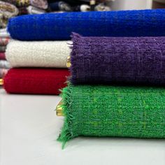 several different colored towels stacked on top of each other