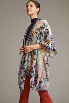 Our Velvet Muse Burnout Ruana is a stunning piece that showcases a beautiful floral design. The floral elements are of varying sizes and were delicately arranged across the fabric, creating a captivating tapestry that exudes serene beauty. The kimono also features a unique border with charming polka dots for a playful touch to its sophisticated design. Wrapped in this luxurious velvet kimono, you will enjoy unparalleled comfort and glamour. The soft, plush velvet fabric feels lovely against your Festive Floral Print Kimono, Bohemian Silk Kimono With Floral Print, Elegant Multicolor Floral Print Shawl, Multicolor Floral Embroidered Festival Shawl, Multicolor Floral Embroidered Shawl For Festival, Patterned Printed Dupatta For Spring, Spring Patterned Printed Dupatta, Bohemian Dupatta For Spring, Bohemian Beige Shawl For Spring