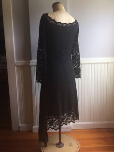 "Black Stretch lace dress that sits right on the shoulder with a beautifully designed neckline. Made in Canada, under the label Joseph Ribkoff. Tag inside indicates it's a size 12( Canada, USA, Mexico) size 40(Germany),Size 14(UK),size 42,(France). Fabric content, 71% nylon, 26% rayon, 3% spandex, 100% polyester lining. The great attribute of this dress is you can hand wash in cold water, dry flat! No dry cleaning, no unnecessary chemicals. Lines are very flattering and fitted to the body with a Black Fitted Dress For Mother Of The Bride, Fitted Black Lace Dress For Wedding, Gothic Lace Dress For Formal Occasions, Gothic Lace Formal Dress, Fitted Black Dress With Delicate Lace, Formal Gothic Lace Dress, Black Fitted Lace Top With Lace Sleeves, Fitted Black Lace Top With Lace Sleeves, Black Lace Top With Fitted Sleeves