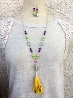 This handmade necklace set is a colorful Bohemian tassel with hand-blown glass beads, semi-precious aquamarine, dyed Quartzite, turquoise, striped agate, and glass beads. The tassel is handmade from cotton fibers. I added silver chain to give it a lariat length. Summer Dangle Jewelry With Large Beads, Multicolor Spiritual Jewelry For Summer, Multicolor Spiritual Summer Jewelry, Colorful Large Beads Jewelry For Summer, Yellow Bohemian Jewelry For The Beach, Yellow Bohemian Jewelry For Beach, Yellow Artisan Jewelry For Beach, Vibrant Yellow Beach Jewelry, Adjustable Multicolor Beaded Tassel Necklace