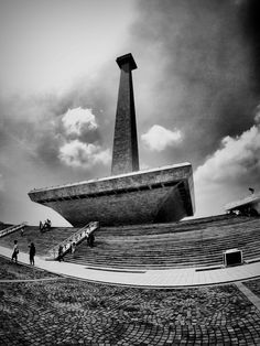 people are walking up and down the steps to an outdoor concert hall in black and white