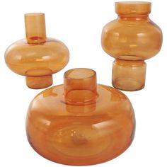 three orange vases sitting next to each other