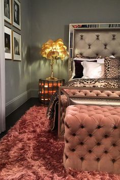 a bedroom with pink carpet and leopard print pillows on the headboard, footstools and bed