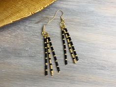 These simple dangling stick earrings are lightweight and stylish. The black and gold beads are perfect for every day use and any outfit! These earrings contain 3 beaded head pins with varying black and gold pattern.  Details: Miyuki seed beads are individually placed on each straight head pin. The straight pins are then curved and placed on a jump ring. Beads may move a little along pin and the beaded pins will move independently of one another. As each piece is 100% handmade, they are unique an Black And Gold Pattern, Beaded Pins, Seed Bead Earring, Diy Seed Bead Earrings, Gold Bead Earrings, Bead Earring, Stick Earrings, Pin Earrings, Diy Jewelry Unique